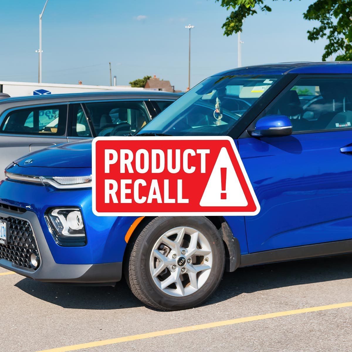 2022 blue Kia Soul in a parking lot with a red "product recall" sticker overlaid