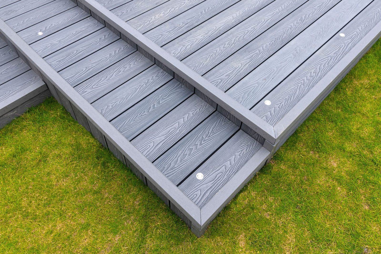Ash Grey Composite Decking Built On Two Levels On A Residential Back Garden